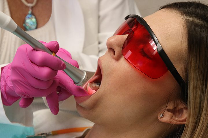 Woman undergoing dental laser treatment