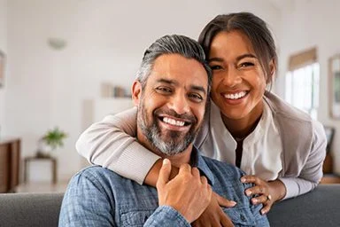 Mature indian couple hugging and looking at camera
